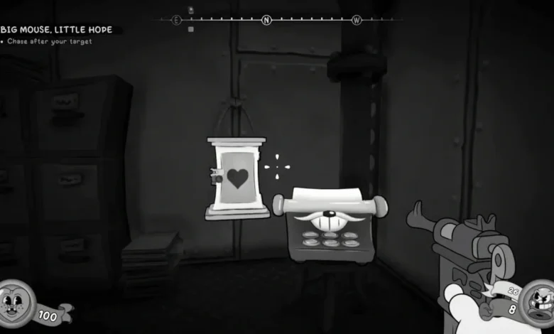 First-person perspective in a black-and-white, rubber-hose style video game, aiming a firearm at an anthropomorphic typewriter next to a door with a heart symbol.