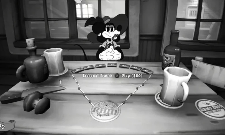 A black and white, 1930s-style cartoon mouse character sits at a tavern table with mugs and playing cards in a scene from a video game.