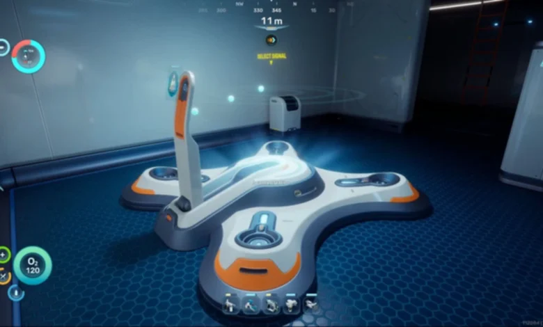 A large, white and orange cross-shaped futuristic device sits on a glowing blue floor inside a high-tech room from a first-person perspective.