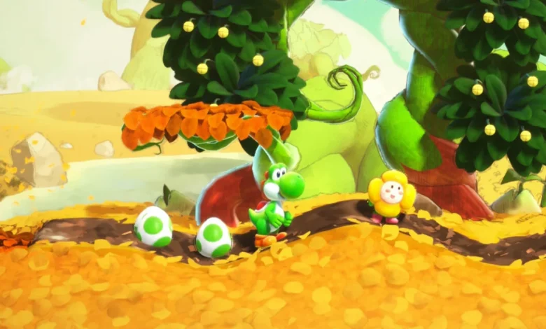 Green Yoshi stands on a path of yellow leaves between two spotted eggs and a smiling yellow flower in a bright, handcrafted world.