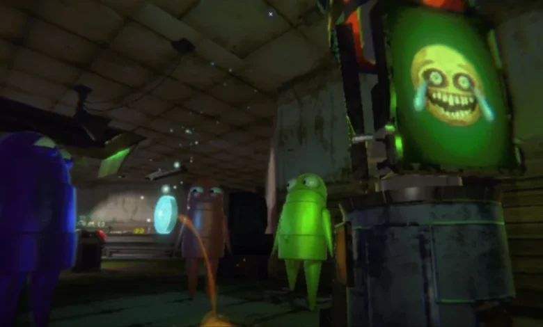 Three small, colorful, armless robot characters stand in a dim workshop looking at a screen displaying a creepy, distorted yellow face.