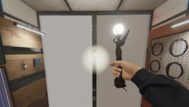A first-person perspective of a hand holding a glowing angel statue inside a workshop or equipment room.