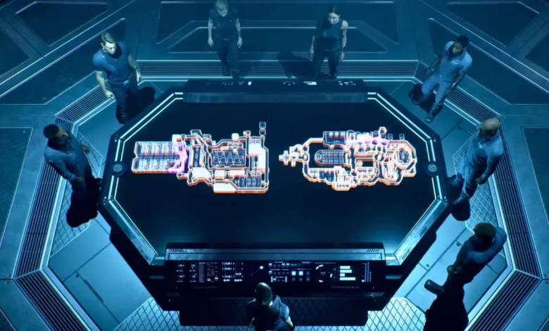 A crew stands around a futuristic briefing table displaying glowing holographic diagrams of machinery in a high-tech room.