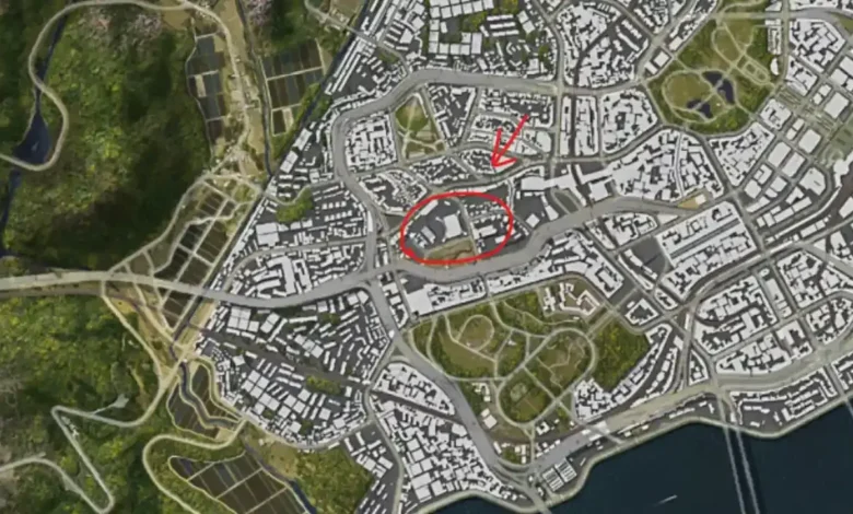An aerial view of a digital city map with a red arrow and circle highlighting a specific urban location.