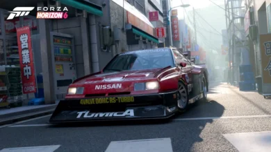 A red Nissan Skyline race car parked on a narrow, sunny Japanese city street with the Forza Horizon 6 logo in the corner.