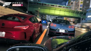 A red and a blue sports car speed through a neon-lit urban city at night under a green bridge in a scene from Forza Horizon 6.