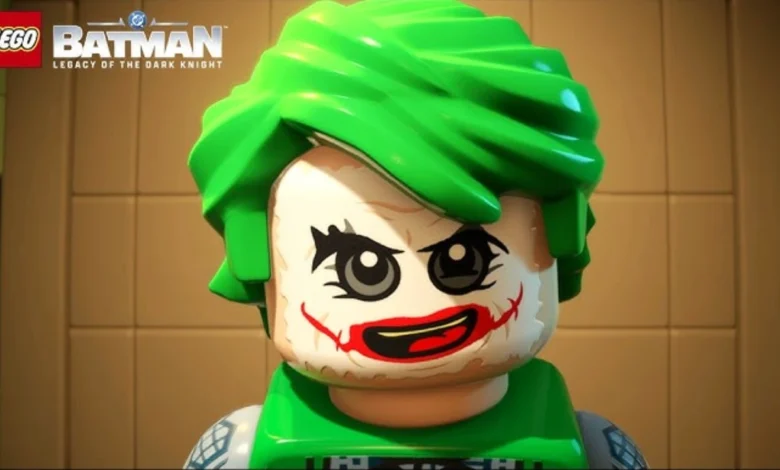 A close-up of a LEGO Joker minifigure with bright green hair and iconic smeared face paint from "LEGO Batman: Legacy of the Dark Knight."