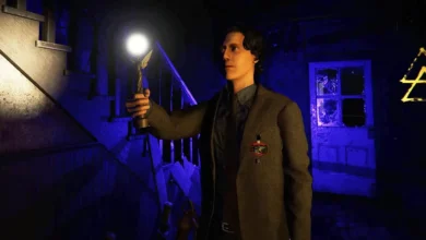 Alan Wake holds a glowing lamp in a dark, blue-lit basement environment.