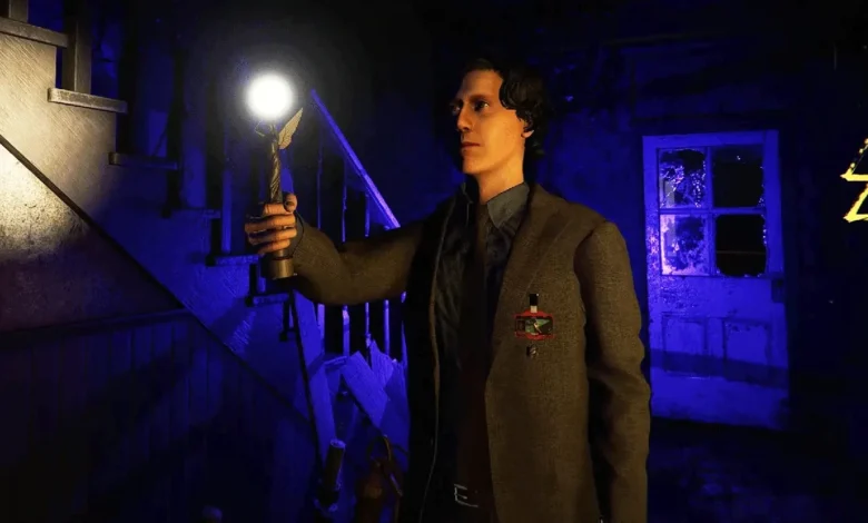 Alan Wake holds a glowing lamp in a dark, blue-lit basement environment.