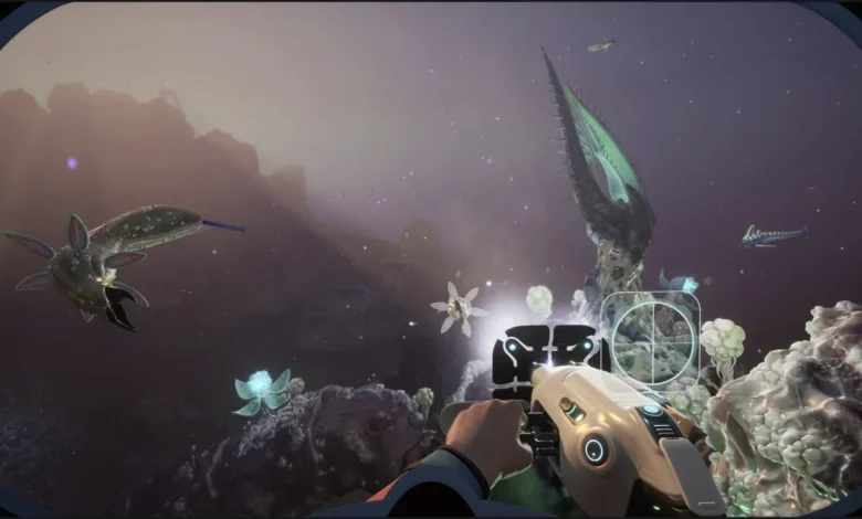A first-person perspective of a player holding a futuristic device while exploring an alien underwater world filled with bioluminescent plants and strange sea creatures.