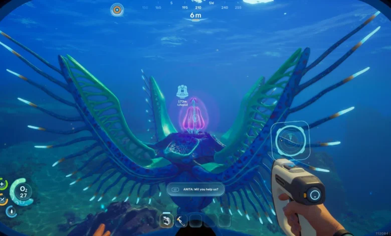 A first-person view from an underwater video game features a massive, vibrant blue and green alien creature with wing-like fins and a glowing pink core.