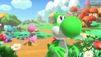 Three colorful Yoshis stand in a vibrant, stylized landscape with rolling green hills and distant snow-capped mountains.