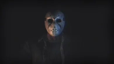 A figure wearing an iconic Jason Voorhees hockey mask emerging from deep shadows.