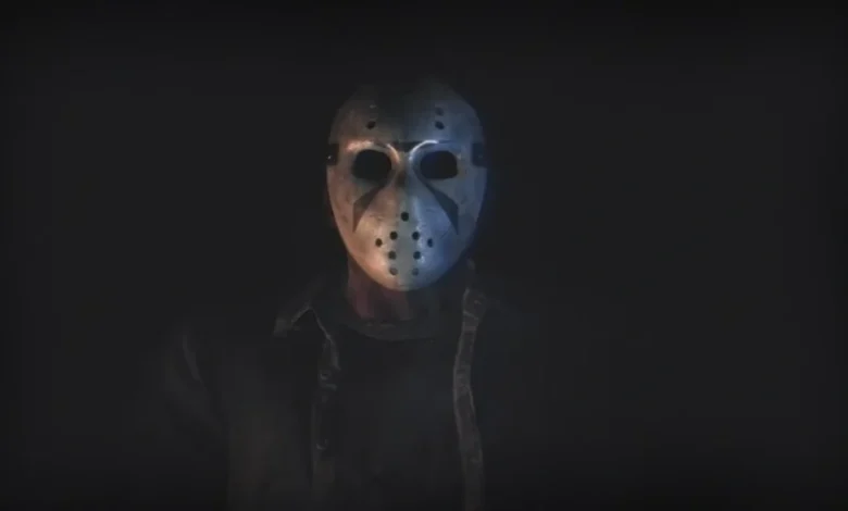 A figure wearing an iconic Jason Voorhees hockey mask emerging from deep shadows.