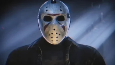 Jason Voorhees wearing his iconic weathered hockey mask in a dark, atmospheric blue-lit setting.