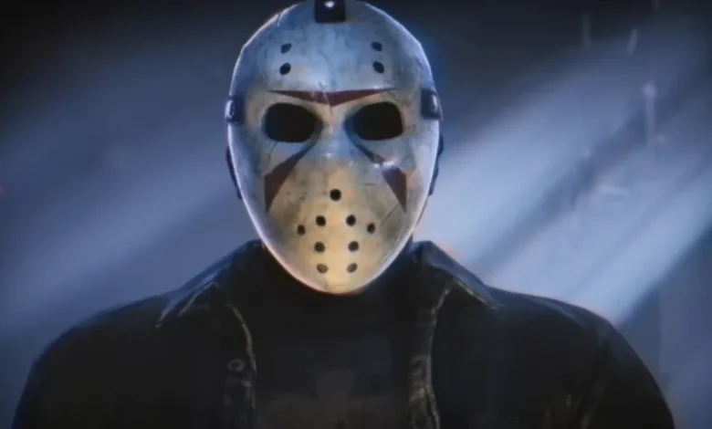 Jason Voorhees wearing his iconic weathered hockey mask in a dark, atmospheric blue-lit setting.