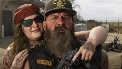 A gritty close-up of a biker couple featuring a bearded man in an "Enforcer" vest holding a revolver while a woman in a red bandana hugs him from behind.