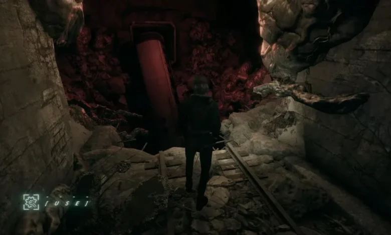 A lone figure stands on ruined tracks in a dark, cavernous tunnel facing a crashed subway car.