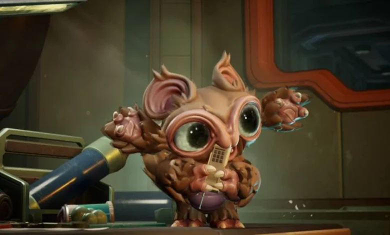 A small, wide-eyed furry creature holds a golden rectangular object in a futuristic, industrial setting.