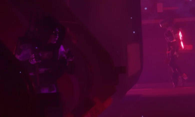 A hooded character hides in the shadows, observing a glowing robotic guard in a futuristic, red-lit environment.