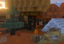 A sunset glows over a blocky Minecraft campsite nestled within an autumn forest of orange and yellow trees.