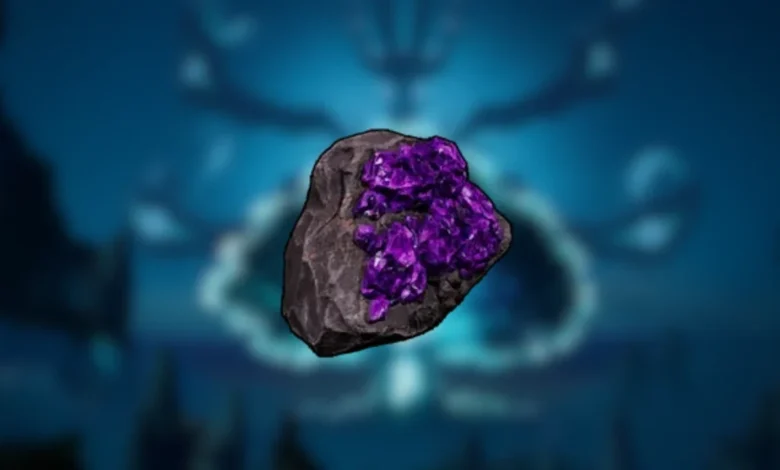 A dark grey rock embedded with vibrant purple crystals, centered against a blurred, glowing blue background.