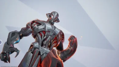 Low-angle shot of the metallic Marvel villain Ultron with silver robotic armor and glowing red internal lights against a minimalist grey background.