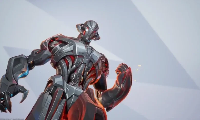 Low-angle shot of the metallic Marvel villain Ultron with silver robotic armor and glowing red internal lights against a minimalist grey background.