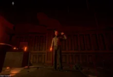 A video game character holds a gun to his head in a dark, red-lit room.